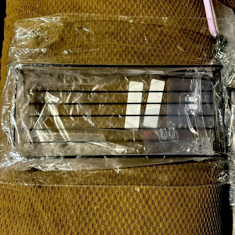 Black stainless steel. Adhesive shower caddy.